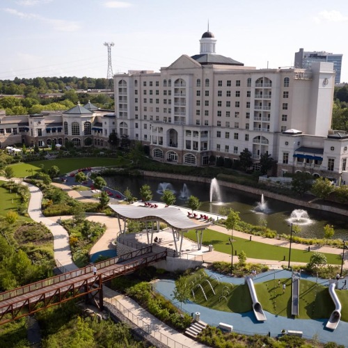 a large building with a pool in front of it