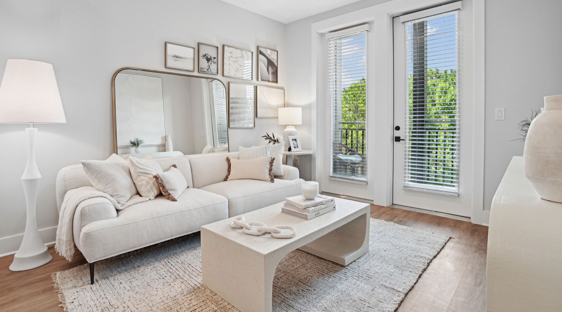 a living room with a white couch and a white table